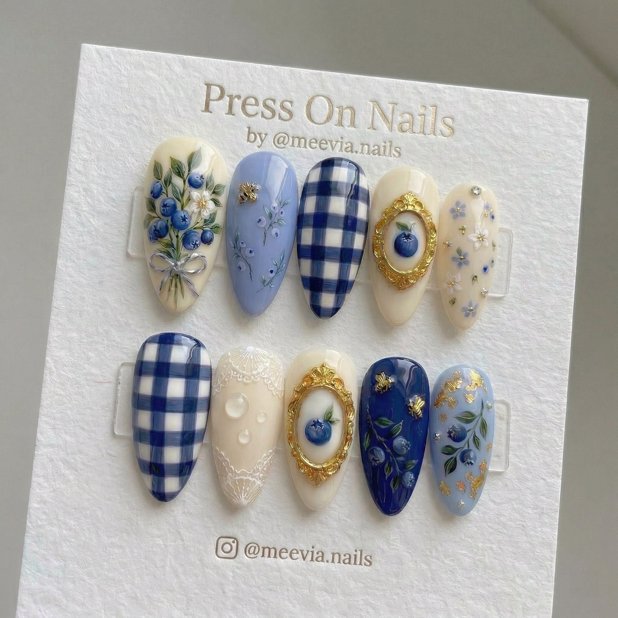 Coffin-shaped press-on nails featuring mixed designs with 3D nail art, metallic accents, and glitter finishes