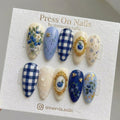 Almond-shaped blueberry and gingham press-on nail set with 3D gold bee accents