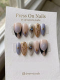 Almond celestial press-on nail set with gold sun, 3D rose, and lavender shimmer