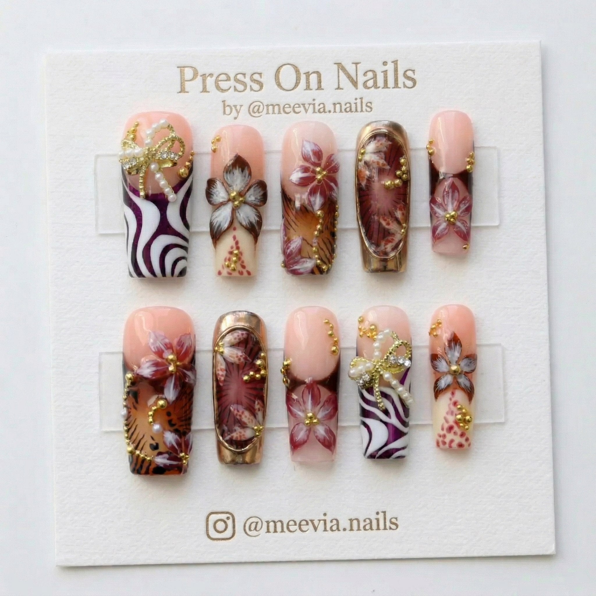 Long square press on nails with 3D pearl bows, floral art, and metallic accents