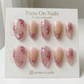Almond-shaped pink press on nails with 3D floral art and gold metallic swirls