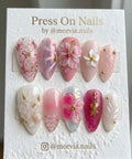 Almond-shaped tropical pink press-on nails with 3D floral and seashell nail art