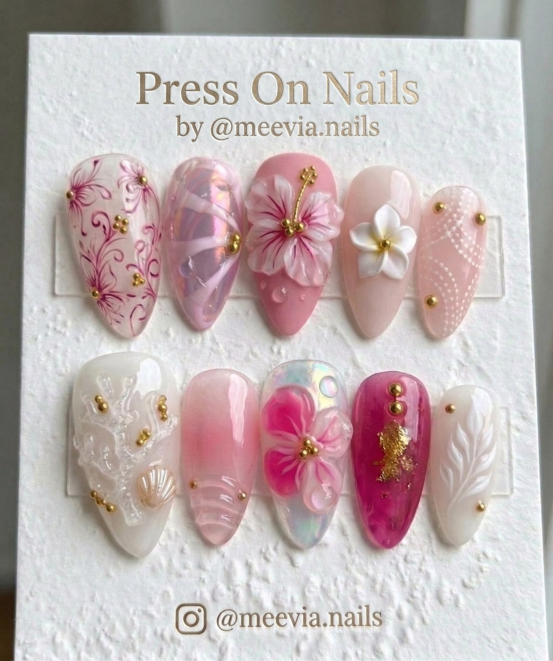 Stiletto-shaped tropical press on nails with 3D floral, shell, and gold accents