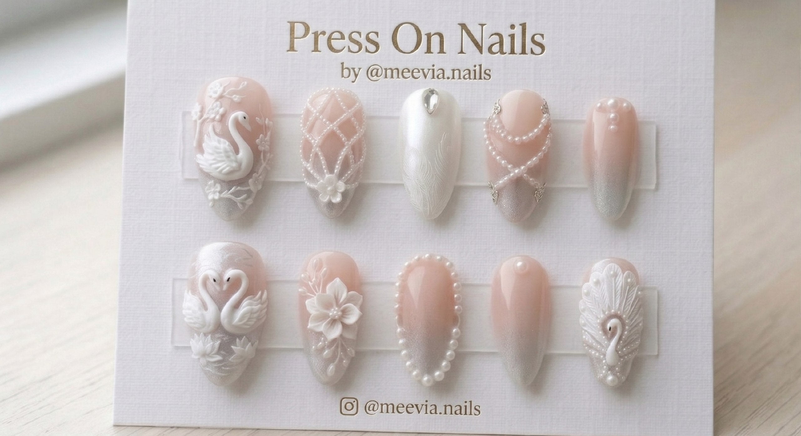 Almond-shaped 3D swan and pearl press-on nail set with white floral art and silver shimmer