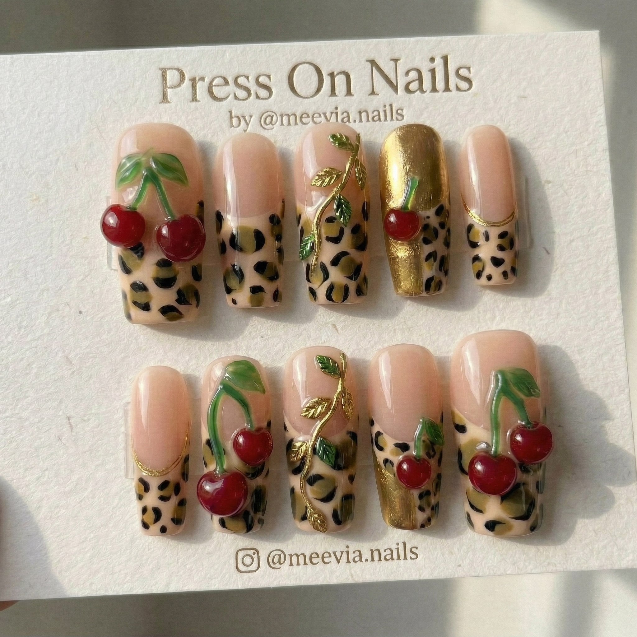 Long square leopard print press-on nails with 3D red cherries and gold vine accents