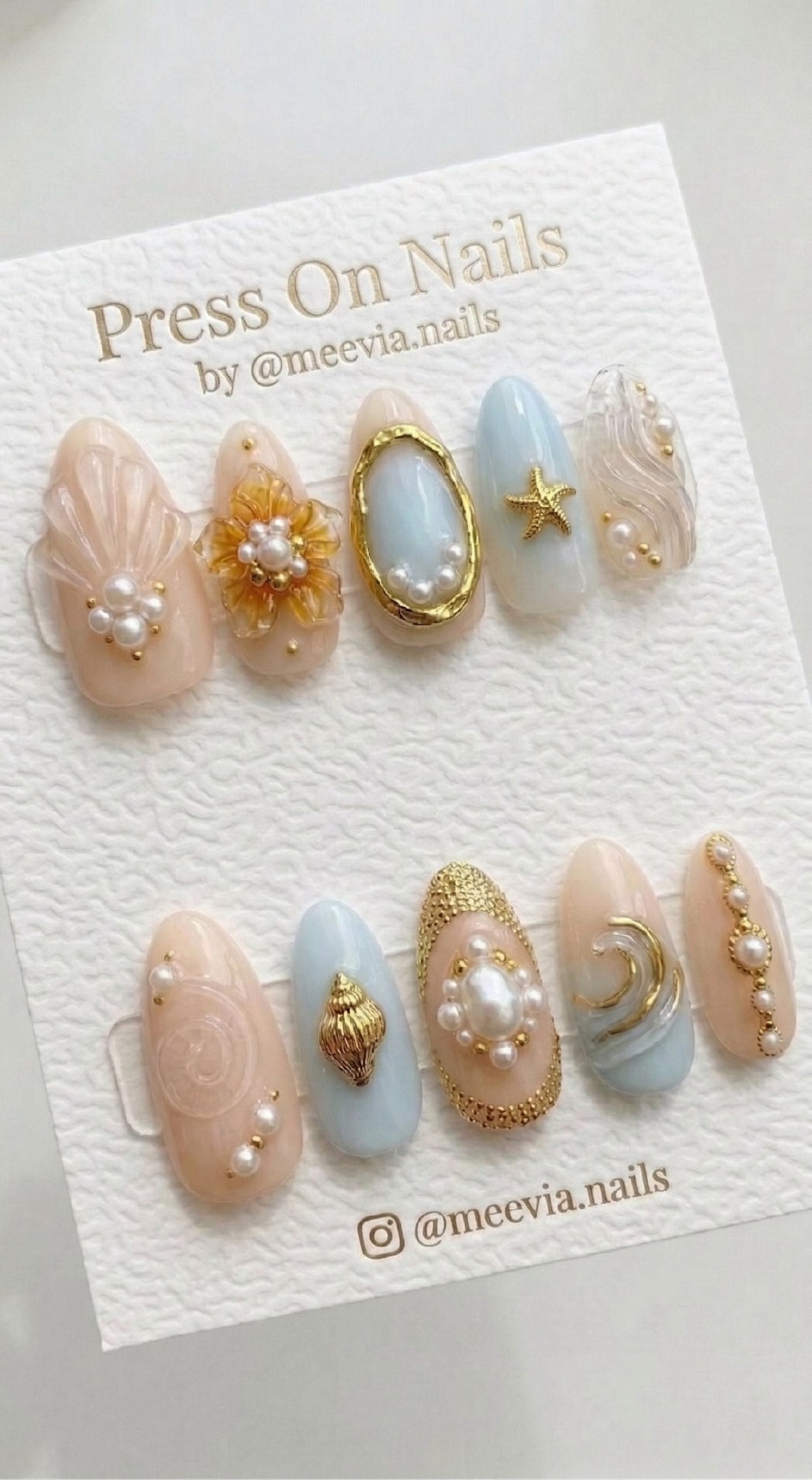 Almond-shaped nautical press-on nail set with 3D gold sea charms and pearls