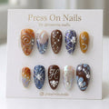 Almond-shaped press on nails with 3D silver wire art, celestial stars, and earthy marble patterns.