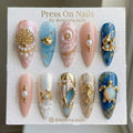 Long coffin-shaped press-on nails in deep green and cream with 3D gold filigree and Saigon lettering.