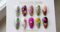 Stiletto-shaped mixed 3D floral and filigree press-on nail set with gems and chrome finishes