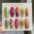 Long coffin press on nails featuring 3D flowers, leopard print, and chrome accents in a colorful mixed art style.