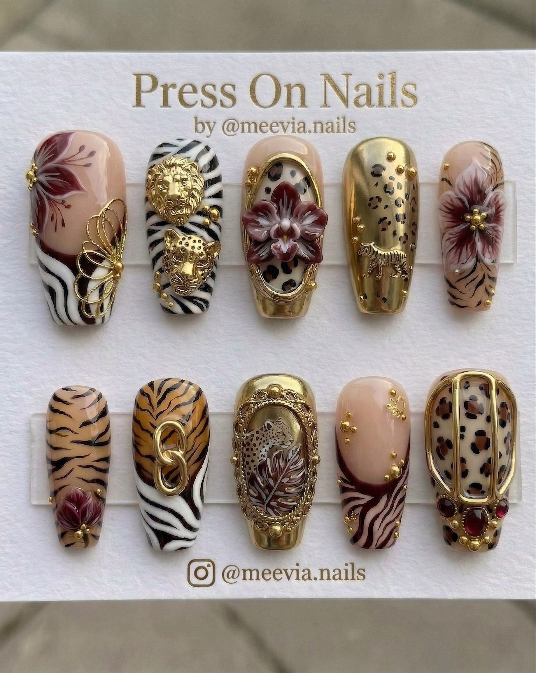 Long coffin-shaped press-on nail set featuring 3D roses, floral sketches, and metallic accents in green, burgundy, and white