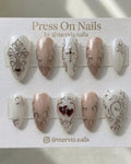 Almond-shaped gothic press-on nail set with silver 3D cross art and red heart accents.