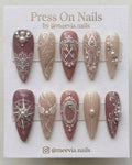 Stiletto-shaped mauve and nude press-on nail set with 3D baroque art, pearls, and crystals.