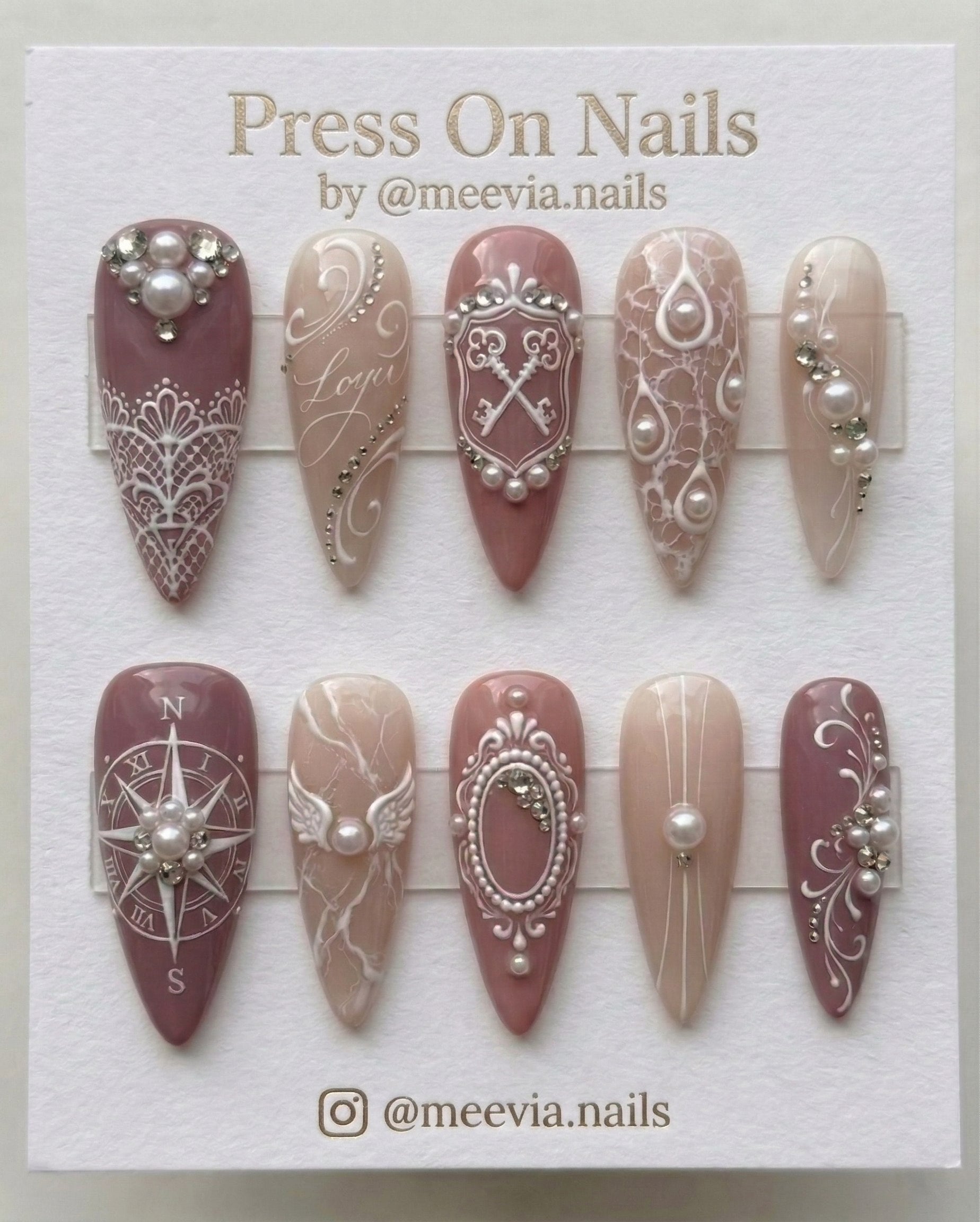 Stiletto-shaped mauve and nude press-on nail set with 3D baroque art, pearls, and crystals.