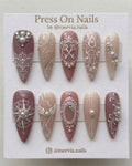Stiletto-shaped mauve and beige press-on nails with 3D vintage keys, pearls, and lace nail art.