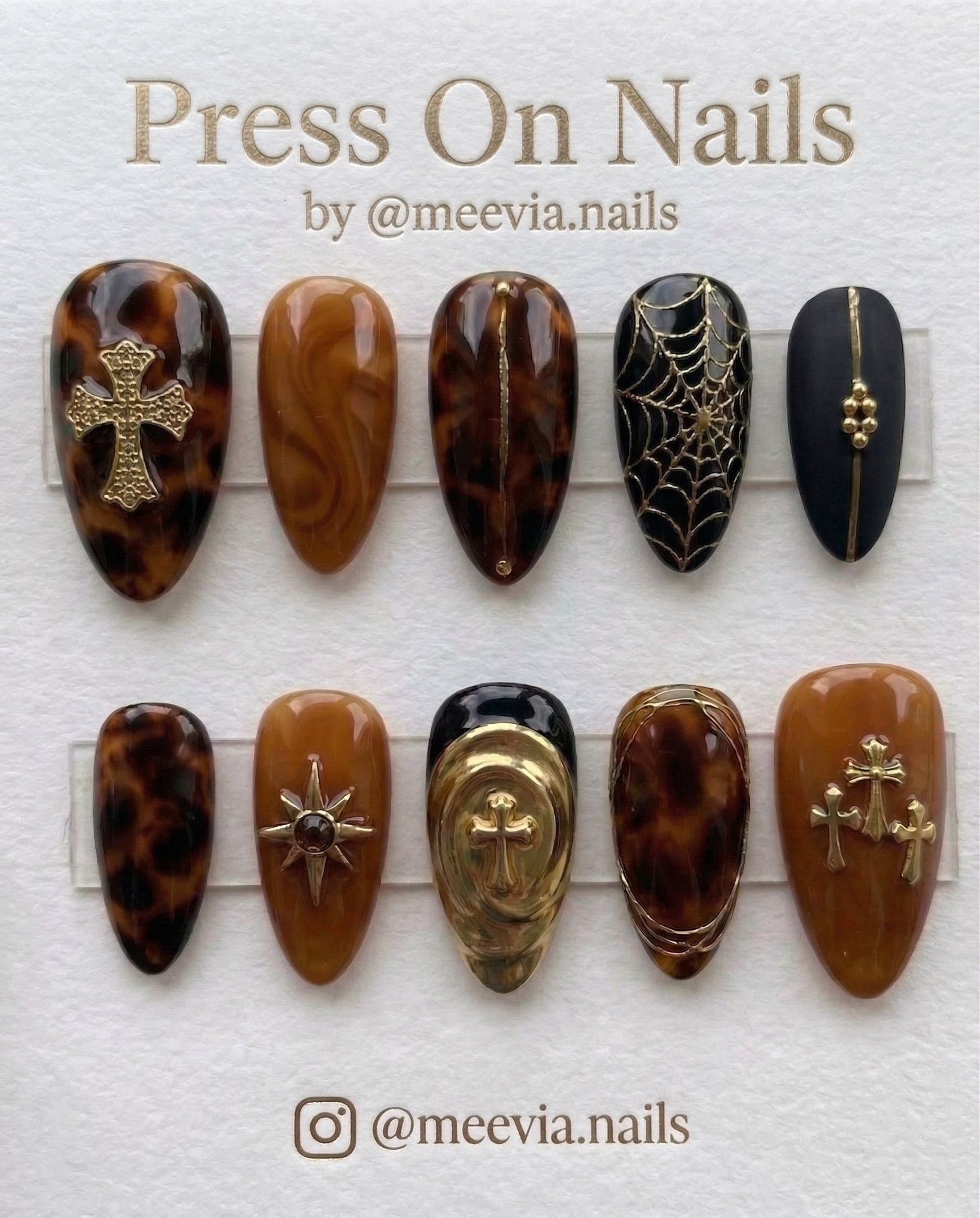 Long stiletto press-on nails with 3D silver webbing, black leopard print, and gothic lace designs.