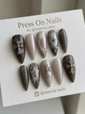 Stiletto-shaped grey and taupe press-on nail set with 3D silver crosses and star motifs