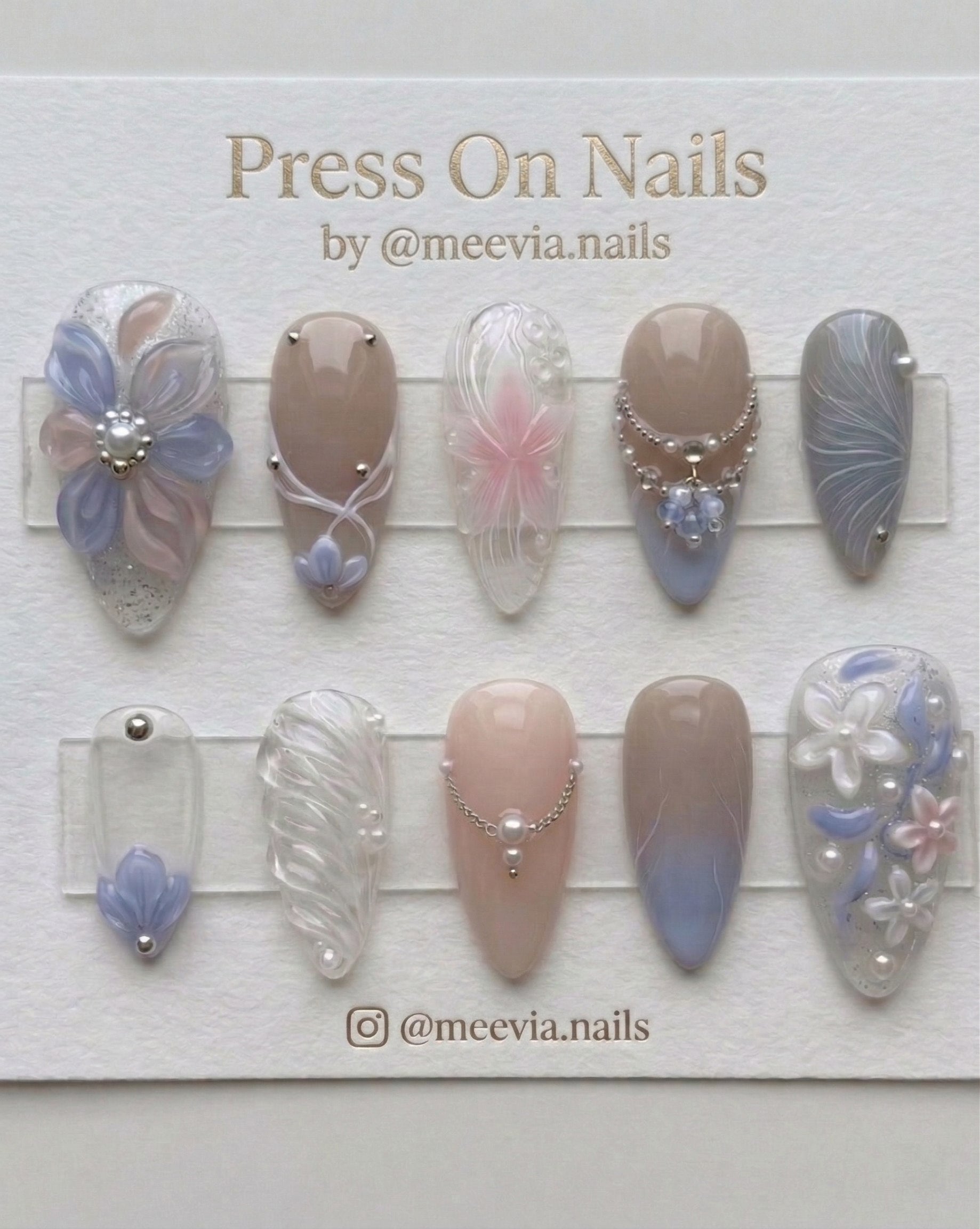 Almond-shaped press-on nail set with 3D floral art, pearls, and blue-lavender gradient