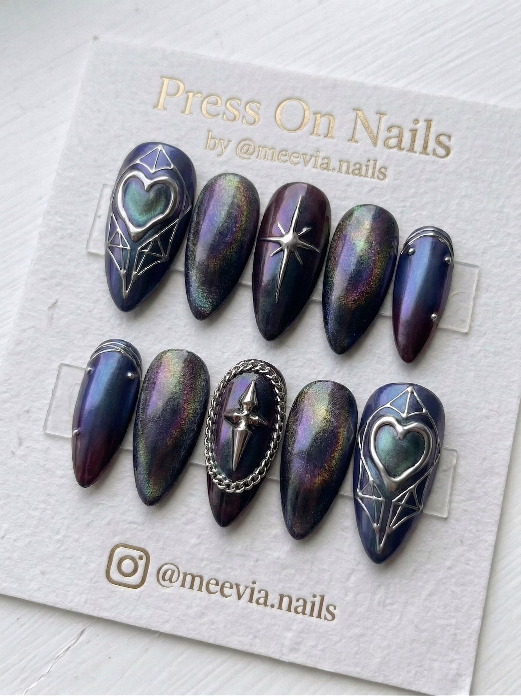 Stiletto-shaped pink press-on nail set with 3D silver chrome swirls and black star accents