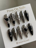 Stiletto-shaped silver chrome and black press-on nail set with 3D steampunk gear motifs and a heart gem