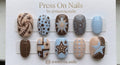 Short rounded press-on nail set featuring stars, circles, and grid patterns in brown, tan, and light blue with silver stud accents.