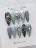 Stiletto-shaped steampunk press-on nails with silver 3D heart and gear motifs