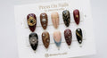 Almond-shaped celestial gothic press-on nail set with 3D gold charms and star motifs
