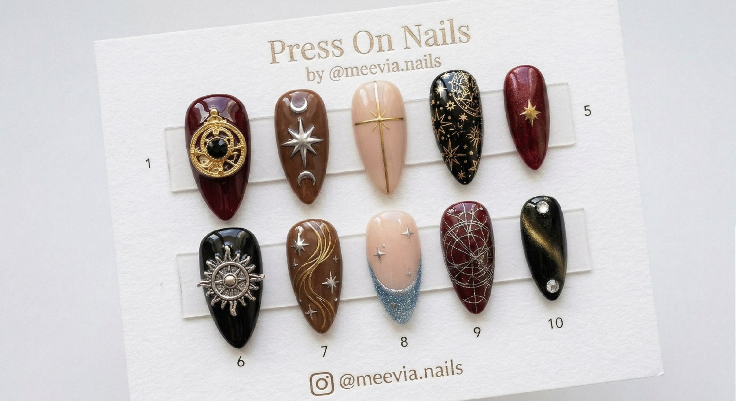 Almond-shaped celestial gothic press-on nail set with 3D gold charms and star motifs