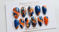 Almond-shaped blue and orange abstract press-on nail set with gold butterfly charms and foil
