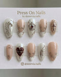 Stiletto-shaped silver chrome press-on nail set with gothic crown and heart motifs
