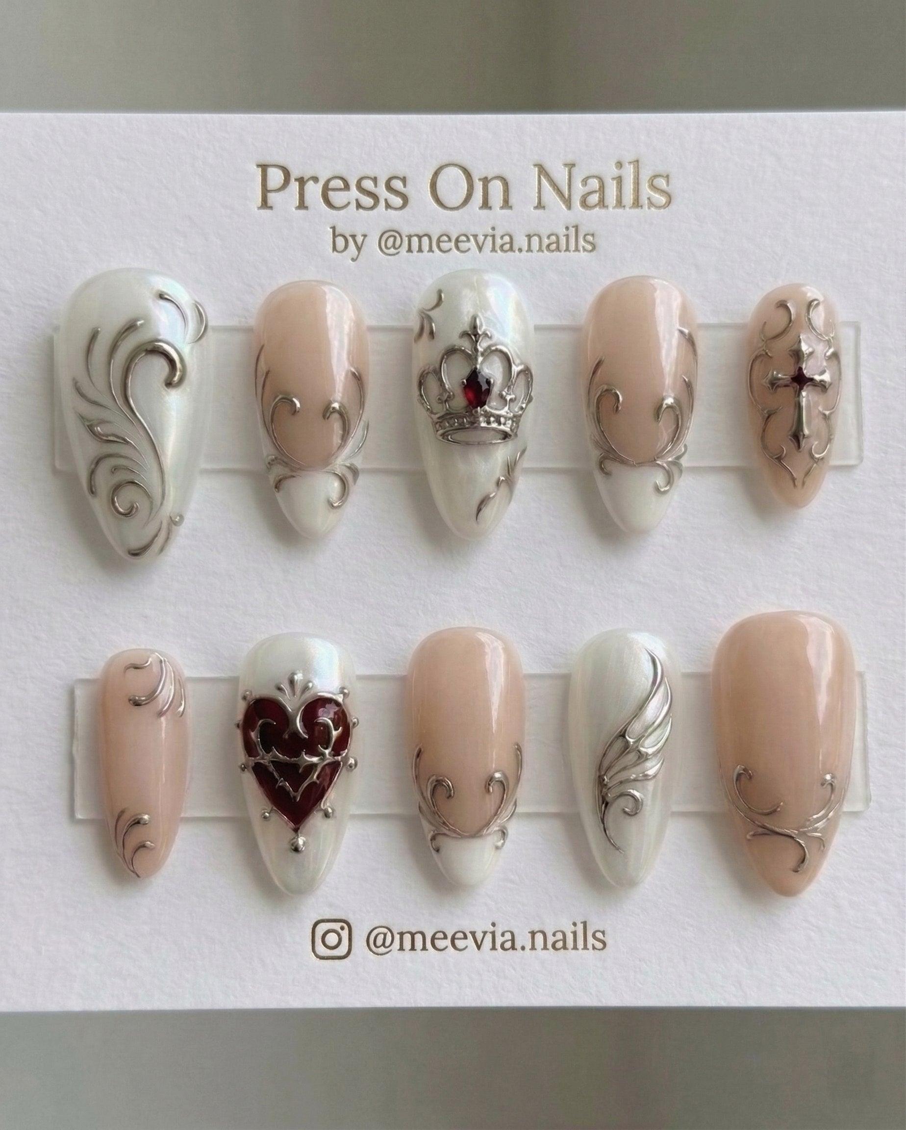 Stiletto-shaped silver chrome press-on nail set with gothic crown and heart motifs