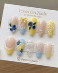 Almond-shaped press on nail set featuring 3D blueberry and lemon designs with yellow bows and lace art.