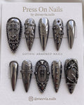 Almond-shaped press on nail set featuring burgundy celestial stars and 3D silver chrome designs