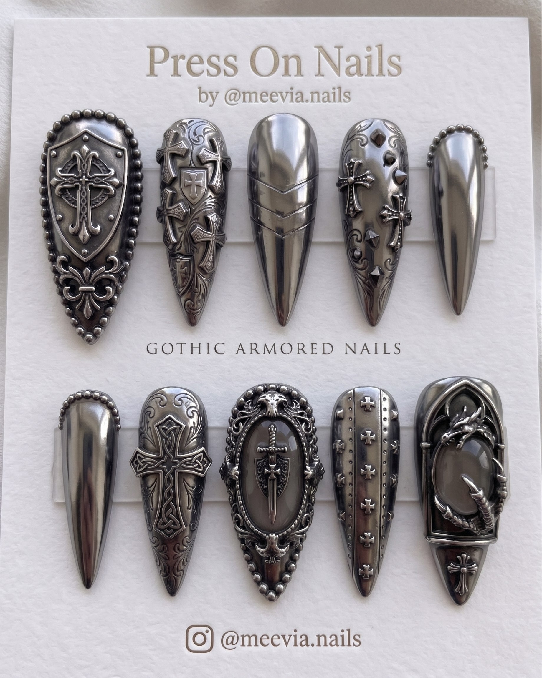 Almond-shaped press on nail set featuring burgundy celestial stars and 3D silver chrome designs