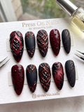 Stiletto-shaped pink press-on nails with 3D star charms and silver metallic accents