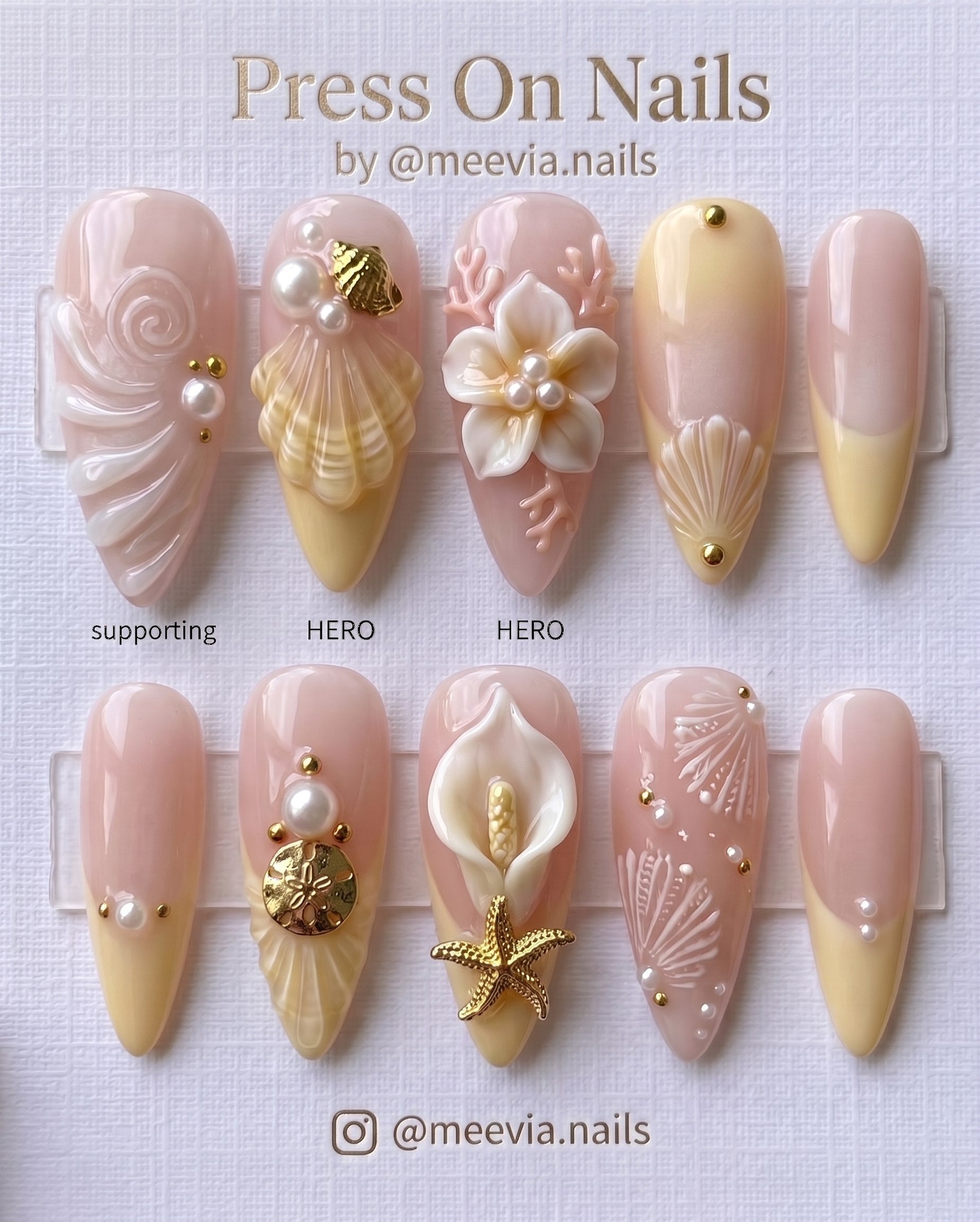 Almond-shaped 3D ocean-themed press-on nails with shells, pearls, and gold charms.