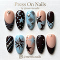 Almond-shaped mocha brown and light blue press-on nail set with star motifs and silver 3D nail art studs