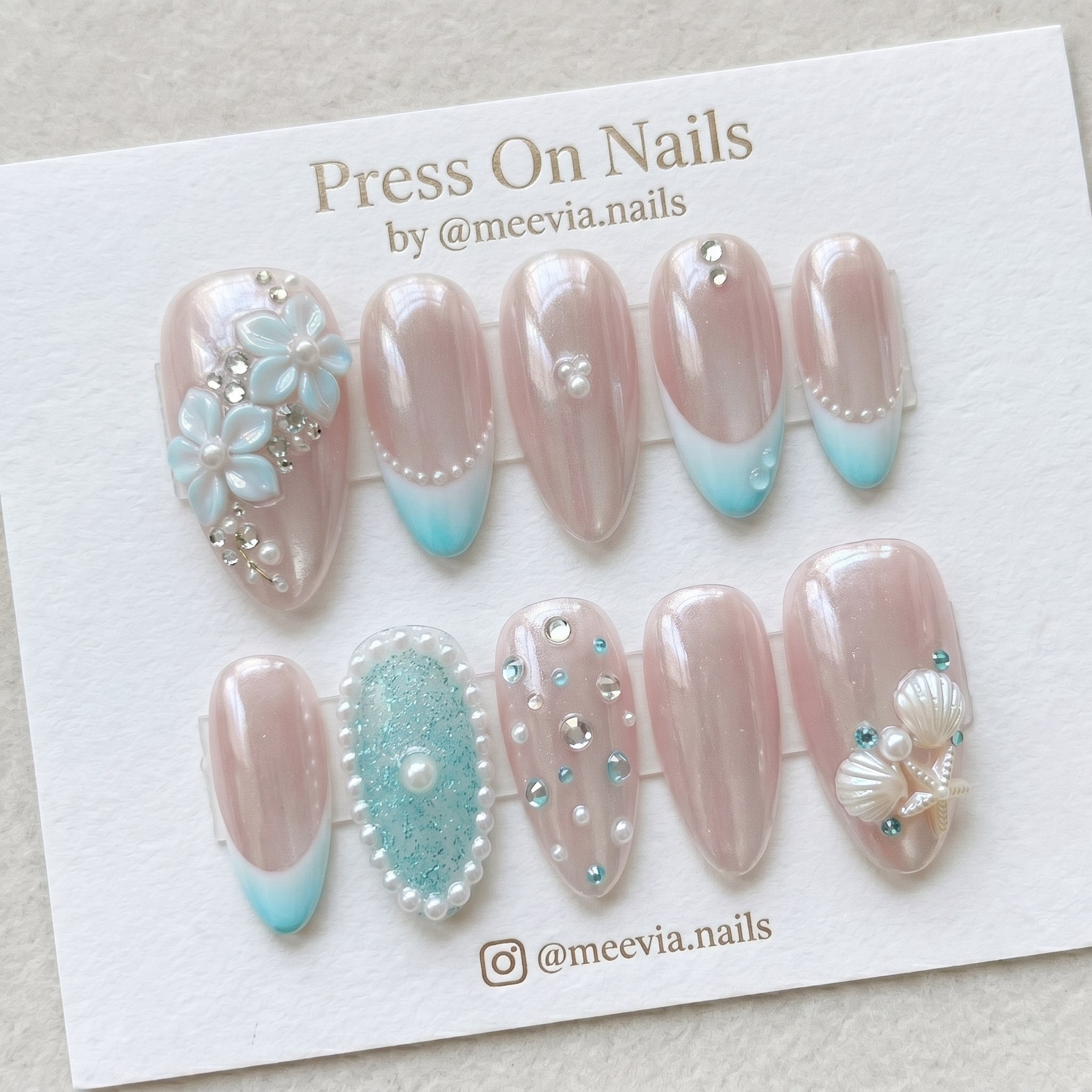 Almond-shaped ocean pearl press on nail set with 3D seashells and blue ombre tips