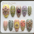 Almond-shaped press on nails featuring 3D floral art, detailed fruit motifs, and water droplet accents.