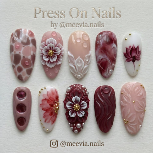 Almond-shaped burgundy and rose press-on nail set with 3D floral art, pearls, and water droplets.