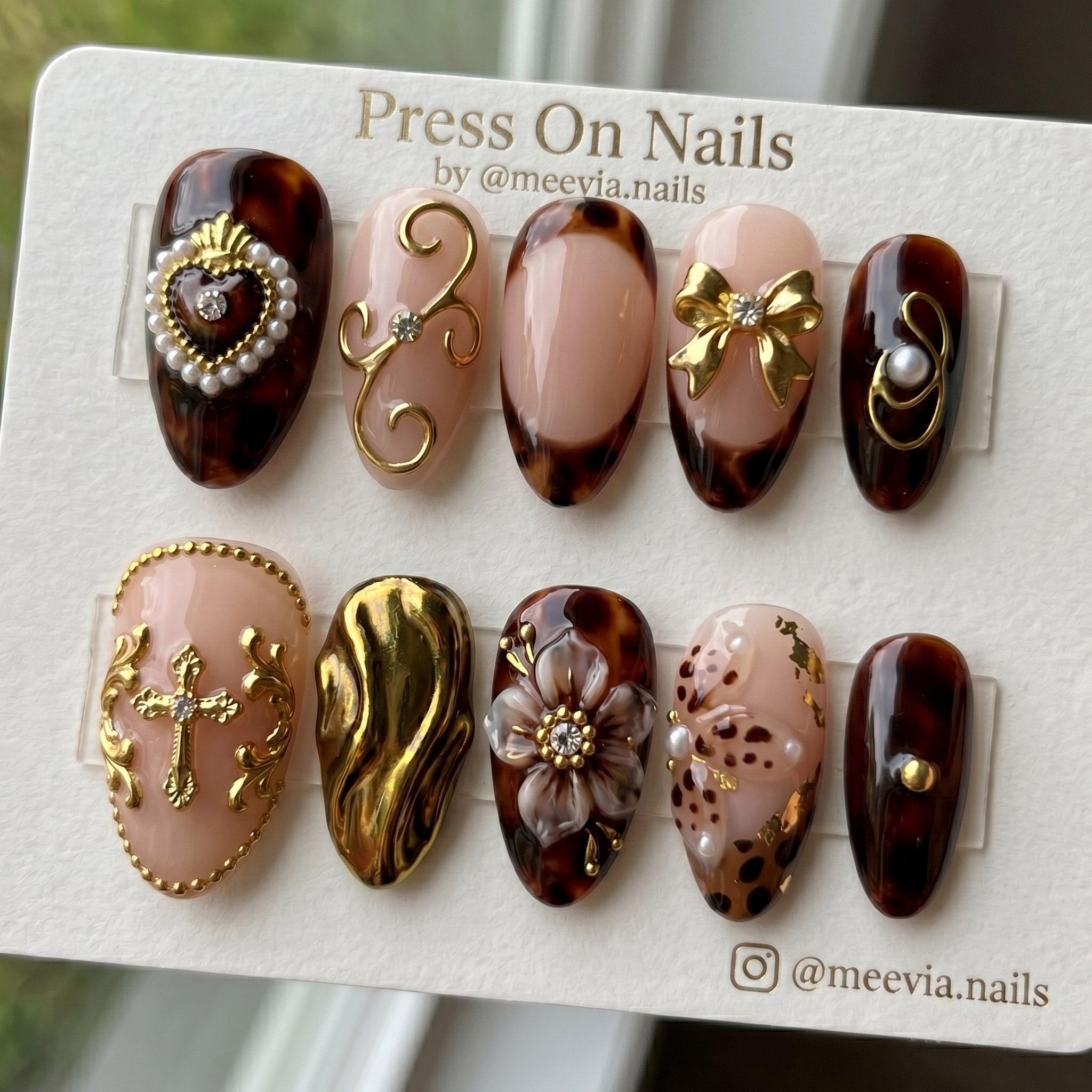 Almond-shaped tortoiseshell press-on nail set with 3D gold charms and pearls