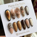 Almond-shaped brown press-on nails with animal print and 3D floral art