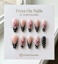 Almond shaped press on nails with 3D pink flowers and black polka dot French tips