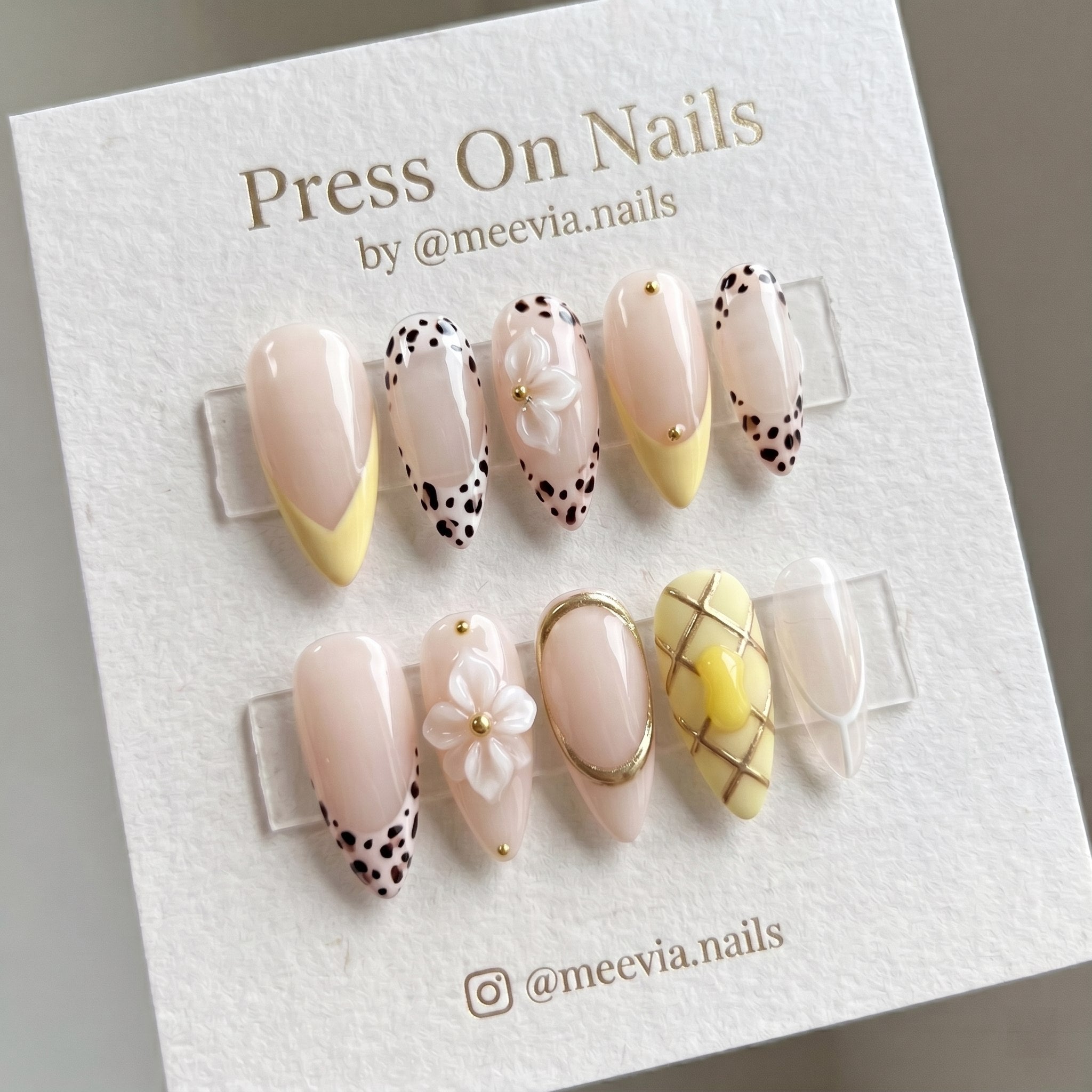 Almond-shaped yellow and leopard print press-on nail set with 3D white flowers and gold accents