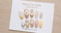 Oval-shaped tropical press-on nail set with 3D floral art, leopard print, and gold accents