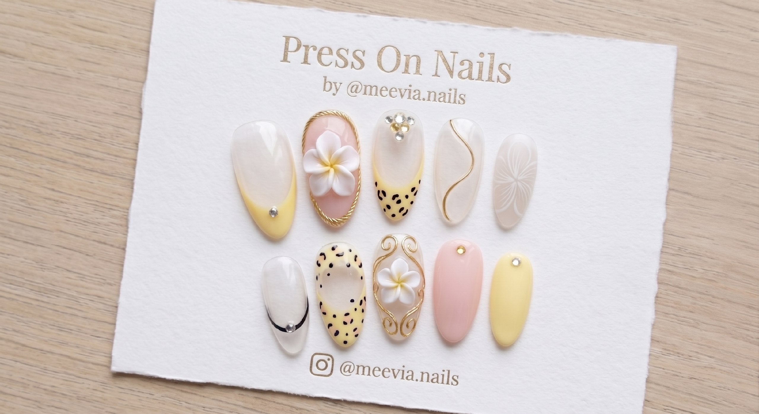 Oval-shaped tropical press-on nail set with 3D floral art, leopard print, and gold accents