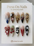 Long stiletto press-on nail set with leopard print, 3D cherries, and gold chain accents.