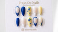 Almond-shaped blueberry and lemon yellow press-on nail set with 3D fruit art and polka dot French tips.