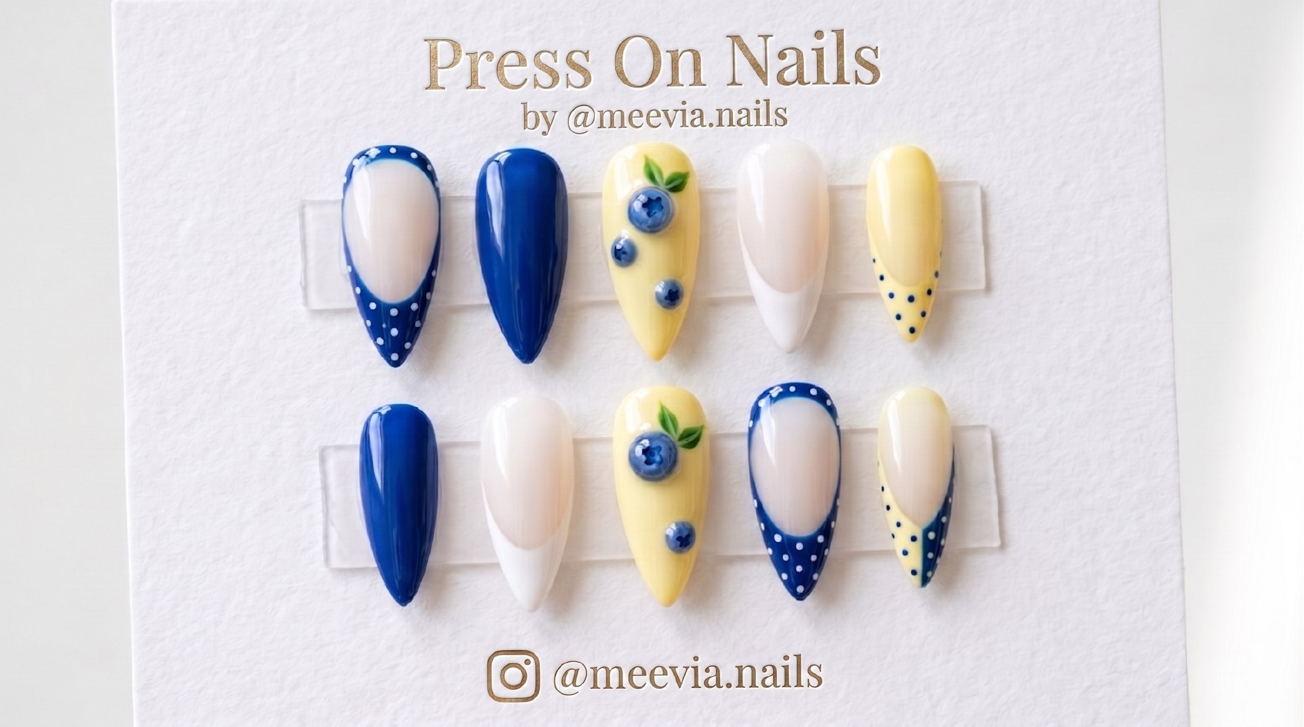 Almond-shaped blueberry and lemon yellow press-on nail set with 3D fruit art and polka dot French tips.