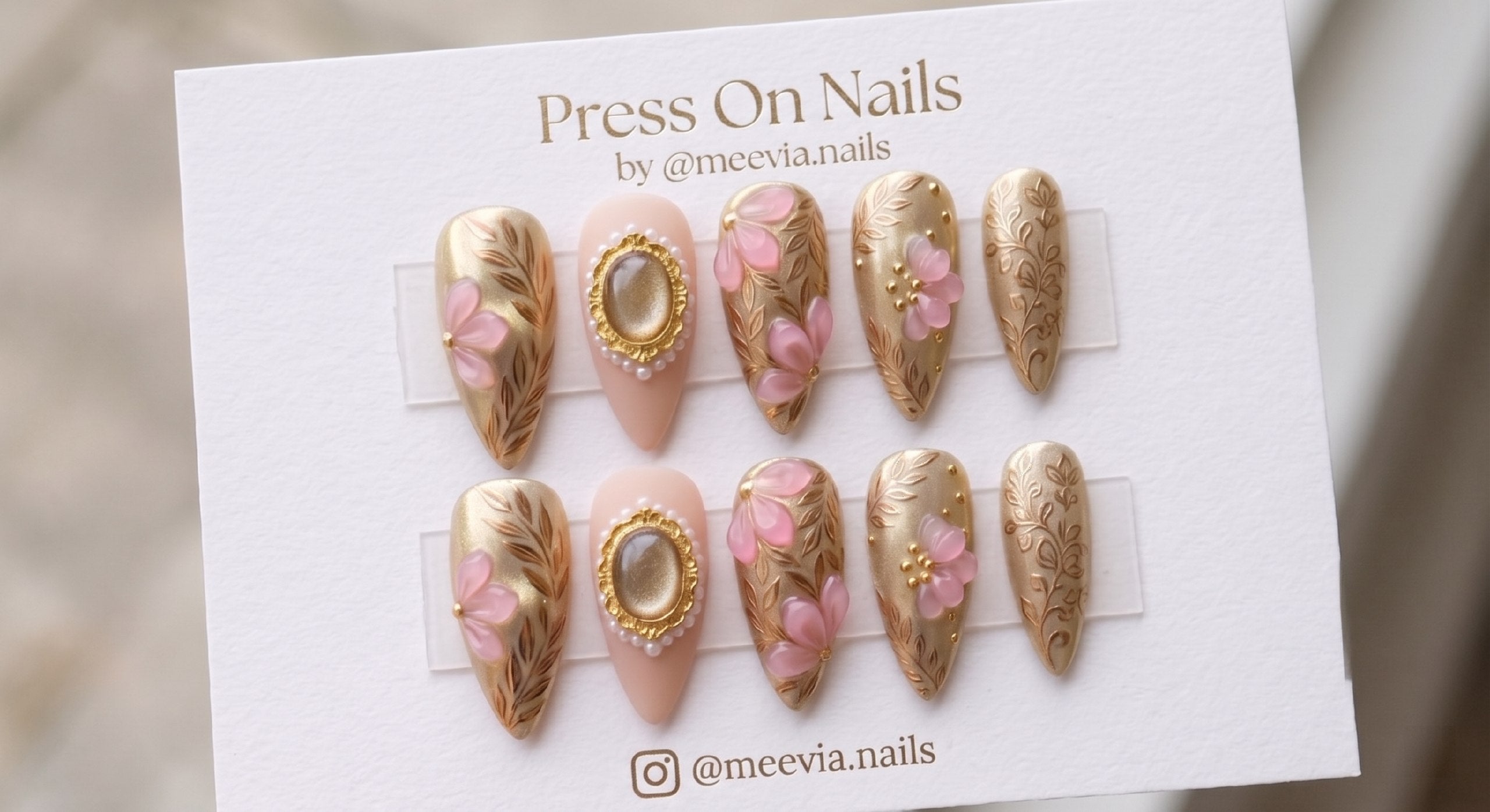 Stiletto-shaped gold and nude press on nails with 3D pink flowers and vintage pearl cameo details
